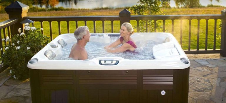A man and woman are relaxing in a hot tub.